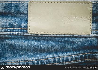 Empty leather label on jeans background with copy space