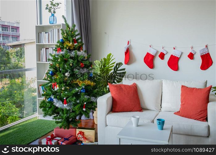 Empty living room is decorated with Christmas tree and gift presents for Christmas Day festival coming soon as background