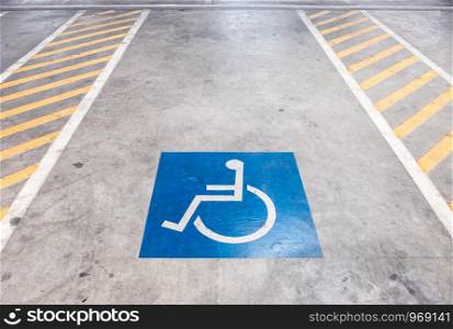 Empty lot of the disabled parking with the symbol in the shopping mall.