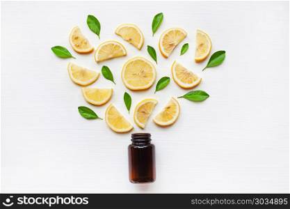 Empty medicine bottle with fresh lemon slices and leaf.. Empty medicine bottle with fresh lemon slices and leaf on white wooden background.