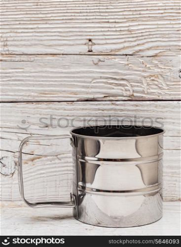 empty metal mug on old wooden table