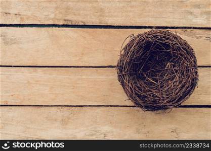 Empty nest on wooden table and background with copy space