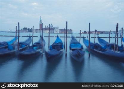 Empty, no tourists Venice. Gondolas moored by Saint Mark square with San Giorgio di Maggiore church in Venice, Italy