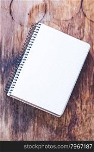 empty notebook on the wooden background