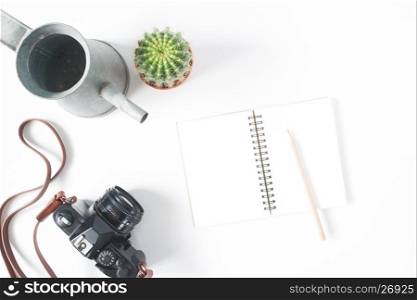 Empty notebook, pencil, film camera, pot of cactus with watering, top view, flat lay, isolated on white background