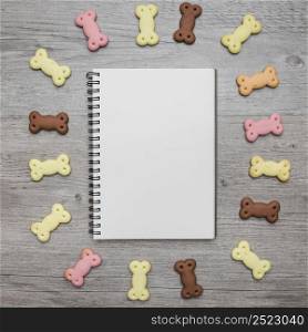 empty notebook with dog snacks around