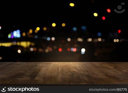 Empty of dark wooden table in front of abstract blurred background of bokeh light . can be used for display or montage your products.Mock up for display of product.