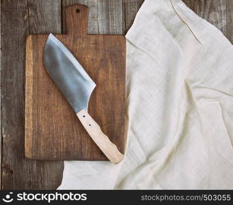 empty old brown wooden cutting board and knife on the table, top view