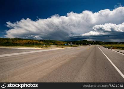 Empty open highway and stormy clouds in Wyoming. Empty open highway and stormy clouds in Wyoming, USA