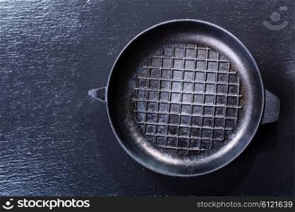 empty pan for grill on dark background