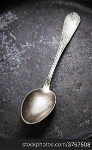 Empty pan with old spoon top view