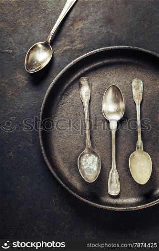 Empty pan with old spoons top view