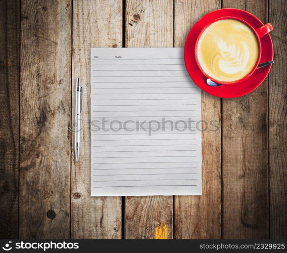 empty paper and pen with red cup coffee on wood table background