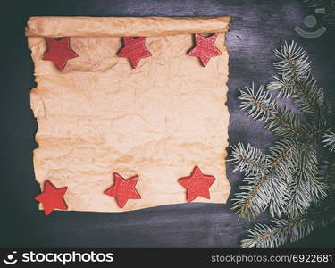 Empty paper roll on a black background and a green spruce branch