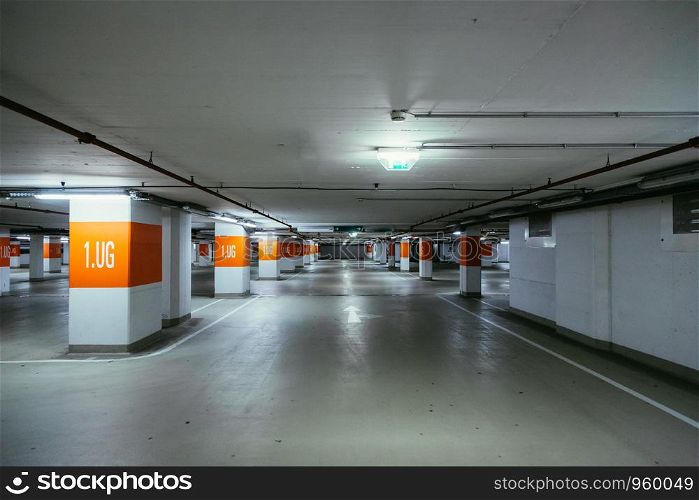 Empty parking garage in the underground. Nobody.