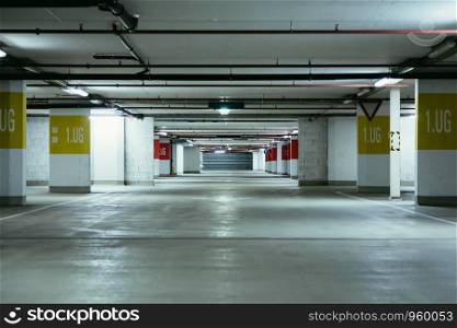 Empty parking garage in the underground. Nobody.