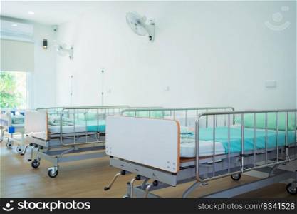 Empty patient beds in ward in nursing home in hospital room in medical and health care concept