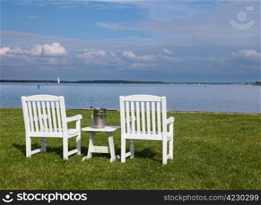 Empty patio chairs by side of the Chesapeake bay overlooking St Michaels harbor