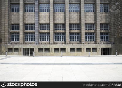 Empty pavement front view of office entrance facade of old style business center