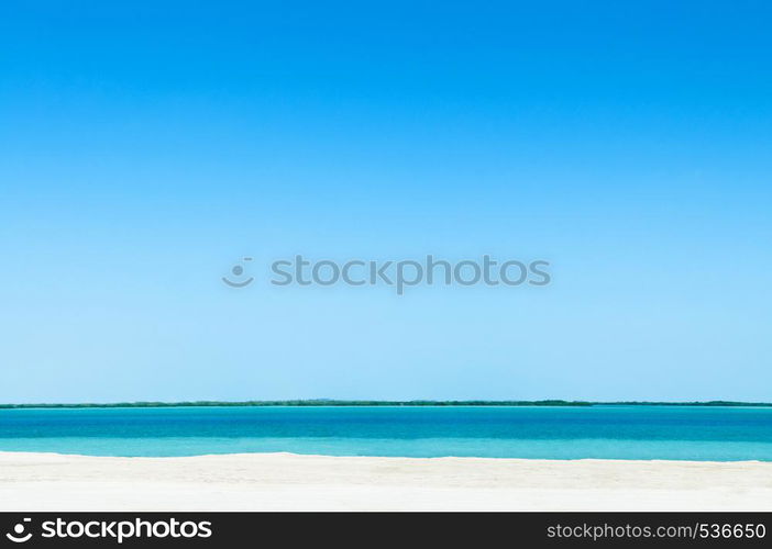 Empty peaceful white Sand beach turquoise blue sea Yas island - Abu Dhabi nature landscape skyline under bright sunlight