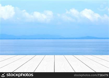 Empty perspective white wood over blur blue sea and sky in summer background, product display montage background, banner