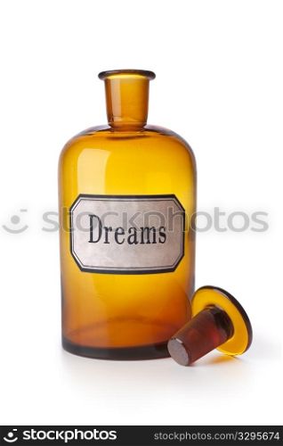 Empty pharmacy medicine bottle with the word dreams on white background