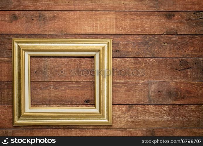 empty picture frame on rustic weathered barn wood wall