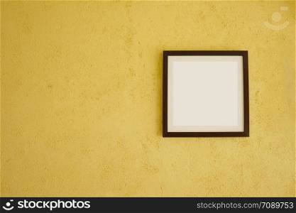 Empty picture frames on vintage yellow walls and have copy space for design in your work concept.