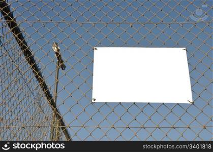 empty placard hanging on a sports court wire fence