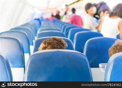 Empty plane interior with few people and stewardess during coronavirus pandemia