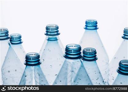 Empty plastic bottles on a blue background. Recycling recyclable plastic. Environment protection. Flat lay top view. Empty plastic bottles on a blue background. Recycling recyclable plastic. Environment protection
