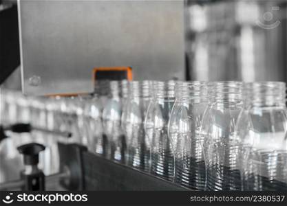 empty plastic bottles on conveyor belt. equipment at the dairy plant. equipment at the milk factory