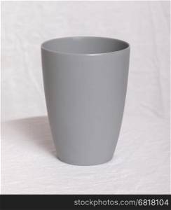 Empty plastic cup isolated on white table sheet