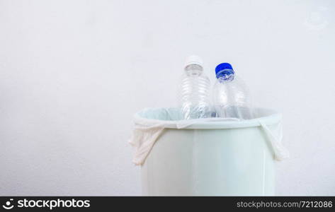 Empty plastic water bottle in recycling bin waiting to be taken to recycle. Concept save the earth.