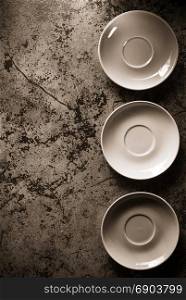 empty plate and saucer at abstract background