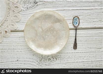 Empty plate dish with spoon food hungry concept monochromatic white wood background
