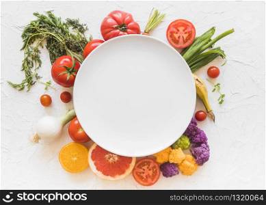 Empty plate surrounded with italian pasta ingredient