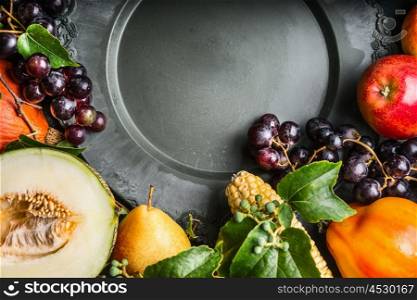 Empty plate with autumn fruits and vegetables, top view, close up, place for text