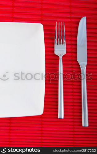 Empty plate with utensils