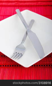 Empty plate with utensils