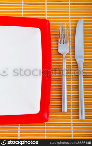 Empty plate with utensils