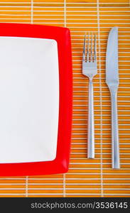 Empty plate with utensils