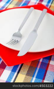 Empty plate with utensils