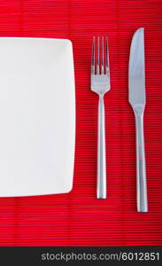 Empty plate with utensils