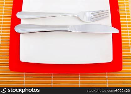 Empty plate with utensils