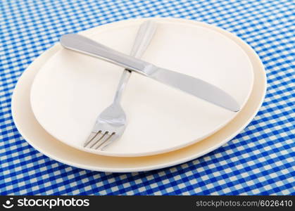 Empty plate with utensils