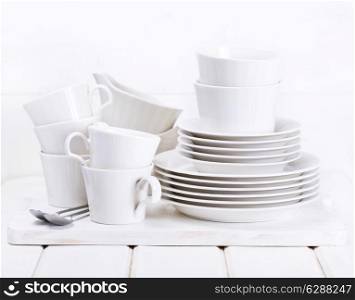 empty plates and cups on wooden background