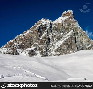 Empty powder filled ski slope overlooking the iconic Matterhorn mountain - captured on Italian side at Cervinia. Empty powder filled ski slope overlooking the iconic Matterhorn mountain