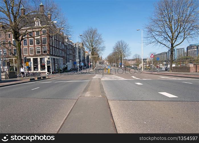 Empty Prins Hendrikkade in the center of Amsterdam during the Corona crisis