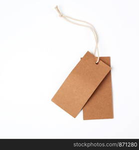 empty rectangular paper brown tag on the rope, white background, close up
